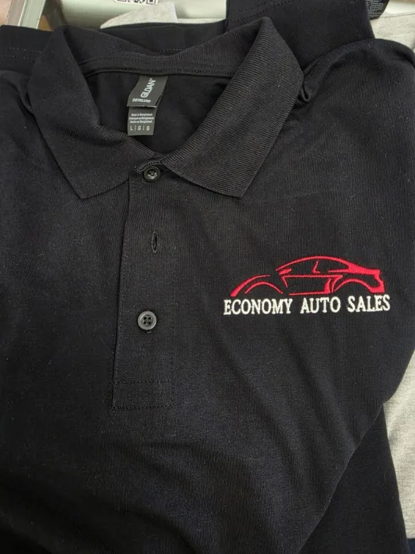 Custom company logo embroidered on black polo shirt
